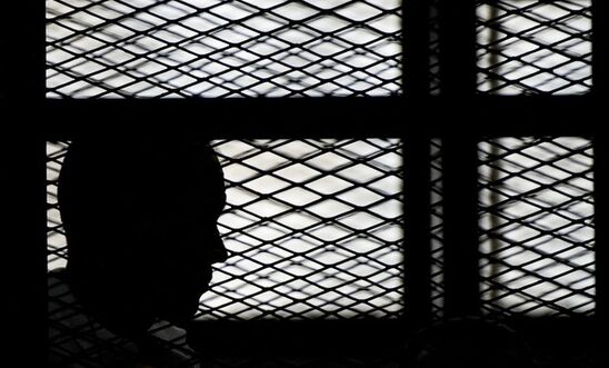 Silhouette of a prisoner in his cell Silhouette of a prisoner in his cell