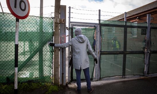 A young male asylum seeker using the only entrance to get inside Napier Barracks, 12 January 2021, Folkestone, United Kingdom. Over 400 asylum seekers are being kept at Napier Barracks in unsuitable.