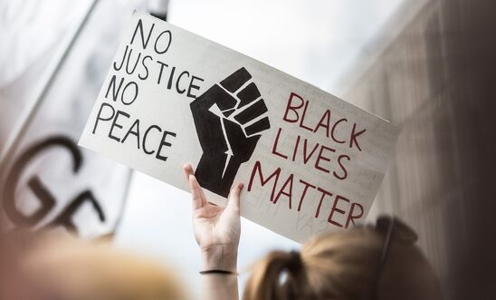 Protester holds sign, no justice, no peace, Black Lives Matter