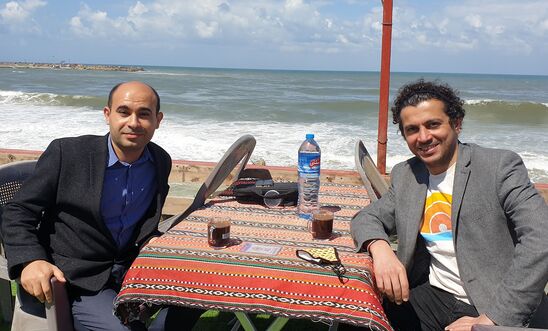 Ahmed Masoud (right) with writer Mahmoud Jouda at Gaza's Maldives cafe