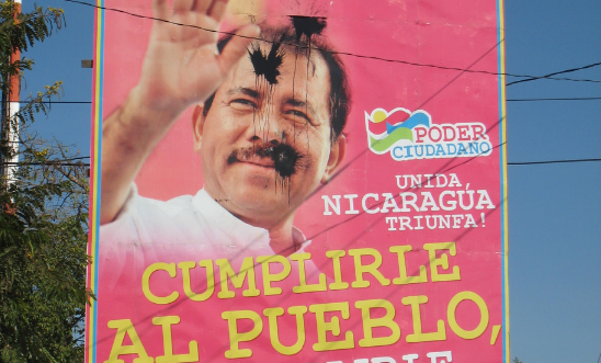 Paint-bombed government poster on a street in Managua. Paint-bombed government poster on a street in Managua.