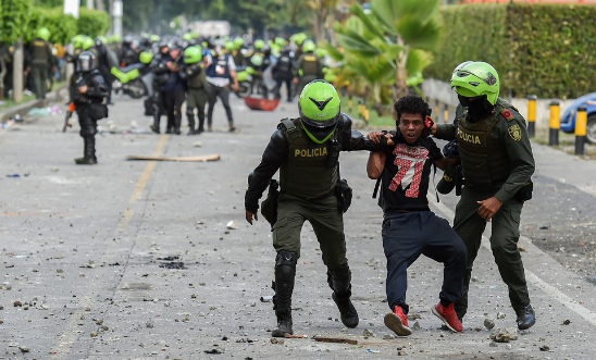  Colombian police officers arrest a demonstrator during a protest against the government in Cali, Colombia, on 4 June, 2021