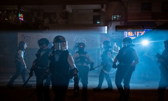 Police wearing helmets and holding up batons are seen in Hong Kong in September 2019 Police wearing helmets and holding up batons are seen in Hong Kong in September 2019