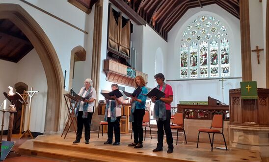 Four singers in a church