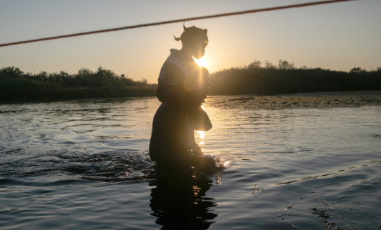 Haitian immigrants cross the Rio Grande back into Mexico from Del Rio, Texas on September 20, 2021