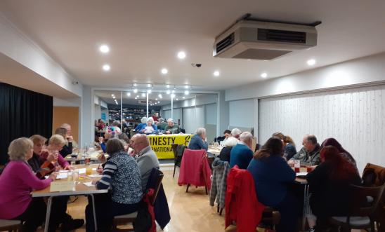 People in a room doing a quiz People in a room doing a quiz