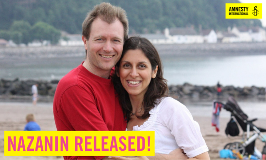 Image of Nazanin & her husband Richard on the beach. Text reads: Nazanin Released! Image of Nazanin & her husband Richard on the beach. Text reads: Nazanin Released!