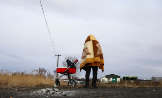 A refugee fleeing from Ukraine is seen after crossing Ukrainian-Polish border due to Russian military attack on Ukraine
