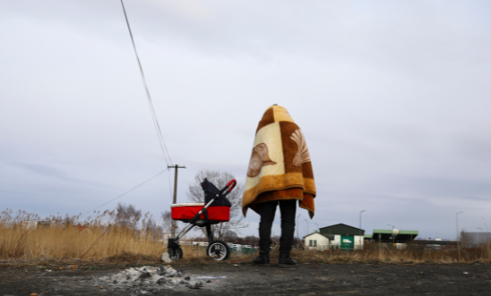 A refugee fleeing from Ukraine is seen after crossing Ukrainian-Polish border due to Russian military attack on Ukraine A refugee fleeing from Ukraine is seen after crossing Ukrainian-Polish border due to Russian military attack on Ukraine