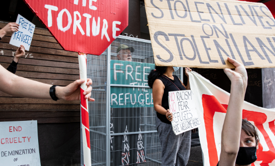 Refugee advocates rally outside detainee hotel Refugee advocates rally outside detainee hotel