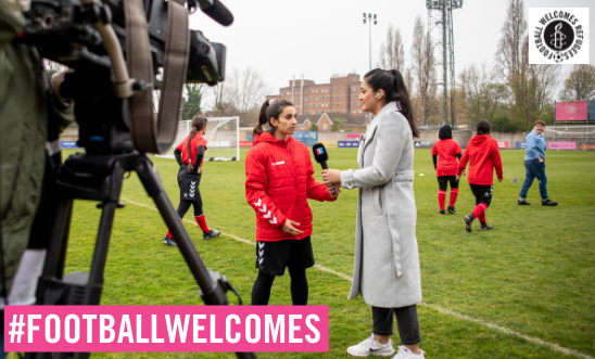 Sabreyah stands on a football pitch and is interviewed while being filmed Sabreyah stands on a football pitch and is interviewed while being filmed
