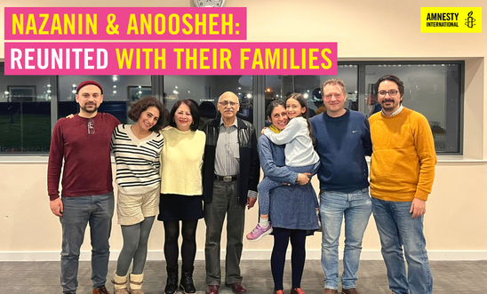 Anoosheh and Nazanin stand in the centre of the image surrounded by their families