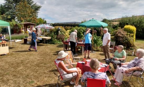 People in a garden drinking tea