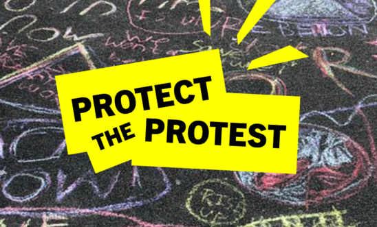 Text reads 'protect the protest' against a background image of climate protest messages written on the road in colourful chalk 