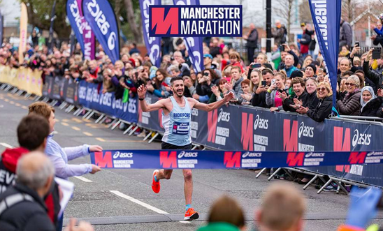 Runner at the end of the Manchester Marathon smiling