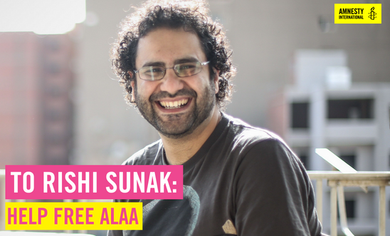 Alaa sits outside wearing a grey t-shirt smiling widely at the camera. Text overaly reads: To Rishi Sunak, Help free Alaa. Amnesty logo