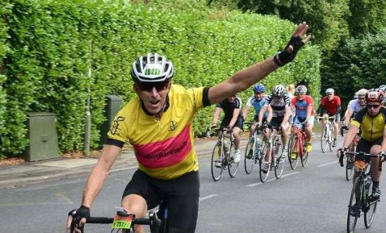 Image of a man on a bicycle during a race.