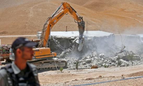 Israeli forces using a Hyundai bulldozer to demolish a Palestinian house in the Umm Qasas area of Masafer Yatta on 25 July 2022