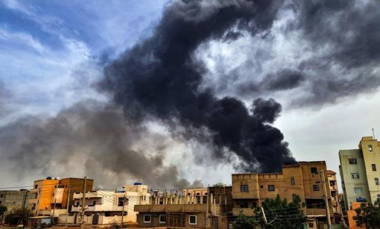 Smoke plumes billow from a fire at a lumber warehouse in southern Khartoum