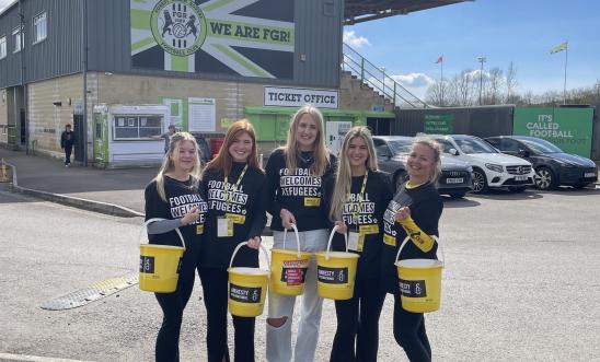 Student fundraisers with collection buckets Student fundraisers with collection buckets