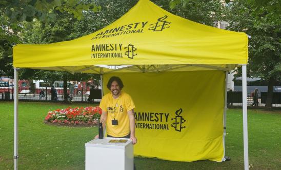 Amnesty representative hosting a big Amnesty stall in a park