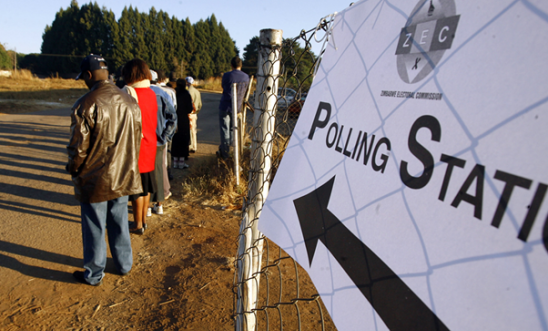 Picture of a queue of people outside of a polling station.