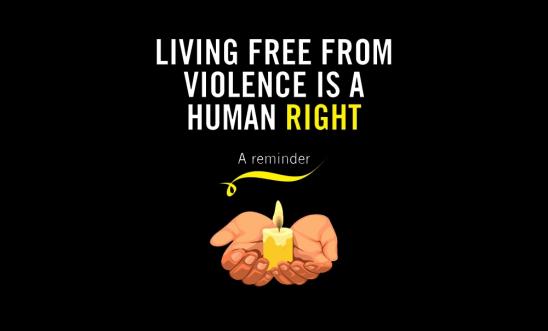 Candle in a hand, with the text reading: "Living Free From Violence Is A Human Right"
