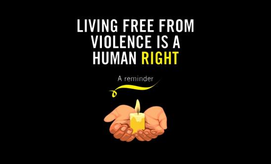 Candle in a hand, with the text reading: "Living Free From Violence Is A Human Right" Candle in a hand, with the text reading: "Living Free From Violence Is A Human Right"