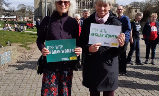 Two AI members holding placards Two AI members holding placards