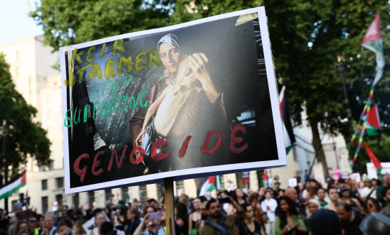 A person holding placard at a protest in London A person holding placard at a protest in London