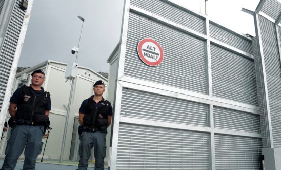 enforcement officers stand in front of a detention centre enforcement officers stand in front of a detention centre