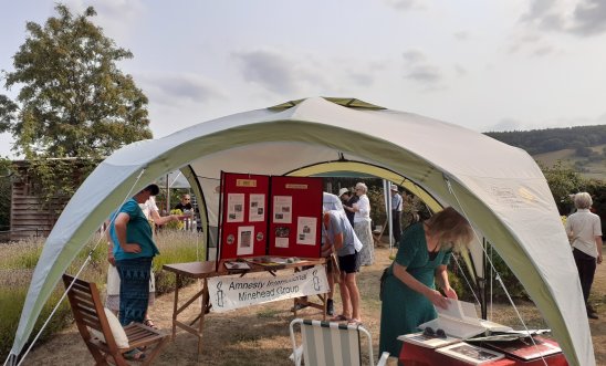 Tent with peopl talking and looking at information