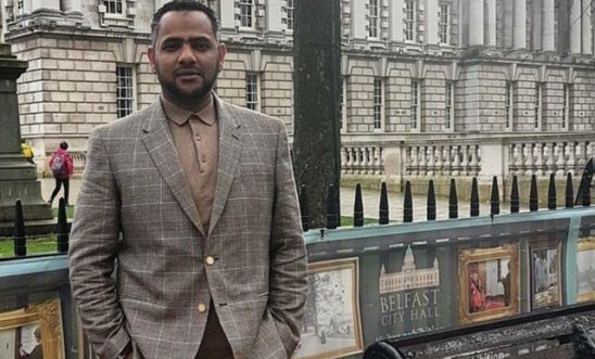 A photo of Ahmed al-Doush posing for a family photo before he was imprisoned