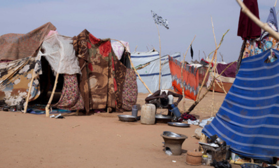 A displaced Sudanese man who fled El-Fasher after the city fell to the Rapid Support Forces (RSF), washes his hair outside a makeshift shelter in the Um Yanqur camp, located on the southwestern edge of Tawila, in war-torn Sudan's western Darfur region on November 3, 2025. 