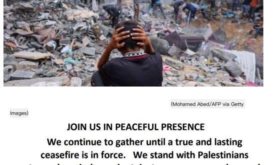 Boy with head in his hands amongst rubble 