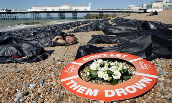 SOS Europe - Die-in, Brighton Beach, England. SOS Europe - Die-in, Brighton Beach, England.