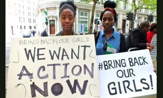 Campaigners holding #Bring back our girls placards Campaigners holding #Bring back our girls placards