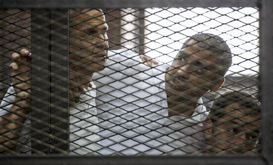 Al-Jazeera journalists (L-R) Peter Greste, Mohamed Fadel Fahmy and Baher Mohamed