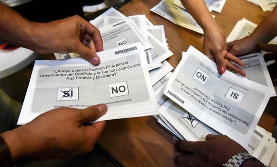 Electoral officials count votes at a polling station in Cali, Colombia