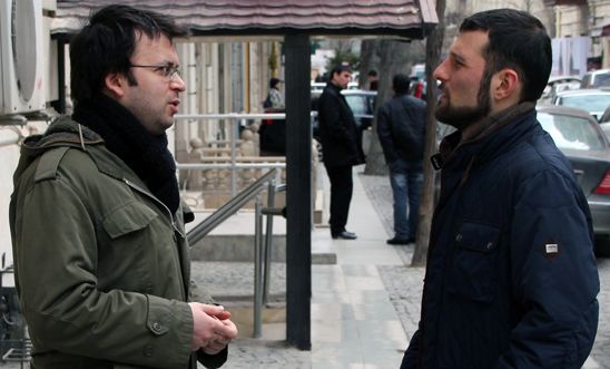 Emin Milli and Adnan Hajizada outside the restaurant where they were attacked