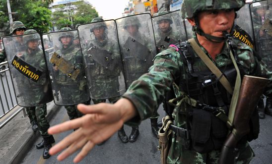 Thai army soldiers stand guard on a city centre street in Bangkok