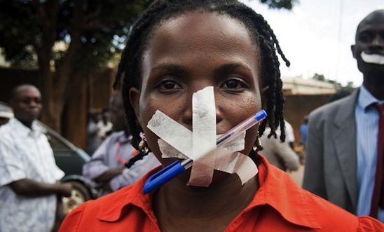 A protestor at the Daily Monitor newspaper poses in Kampala on May 20, 2013