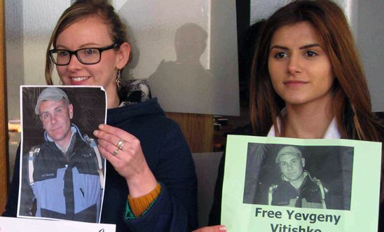 Activists from Amnesty Chelmsford hold photos of Yvgeny