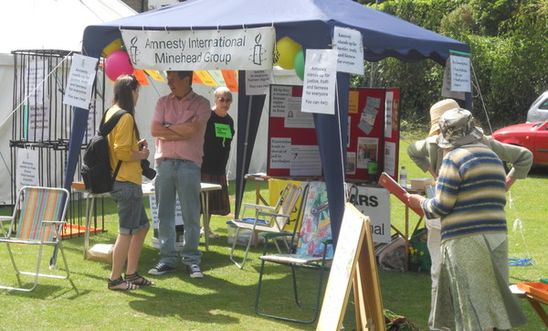 Stall at fete with Amnesty information, letters and petition