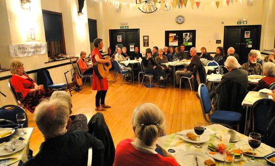 Photo of the supper concert with Saffron singing and playing her guitar