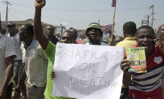 Pro-Biafra supporters hold a placard as they march through the streets of Aba, s