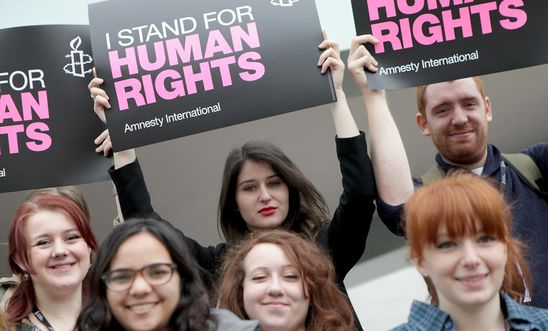 Activists hold placards saying 'I stand for human rights'