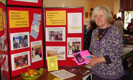 Information stall with an Amnesty group member Information stall with an Amnesty group member