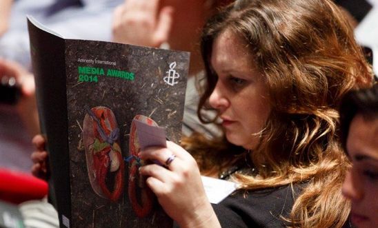 Woman reading brochure - Media Awards