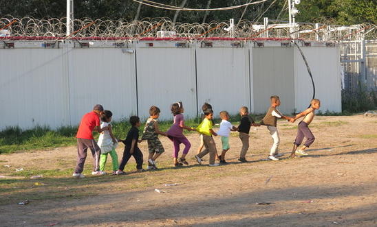 Children making the most of things in a refugee camp Children making the most of things in a refugee camp